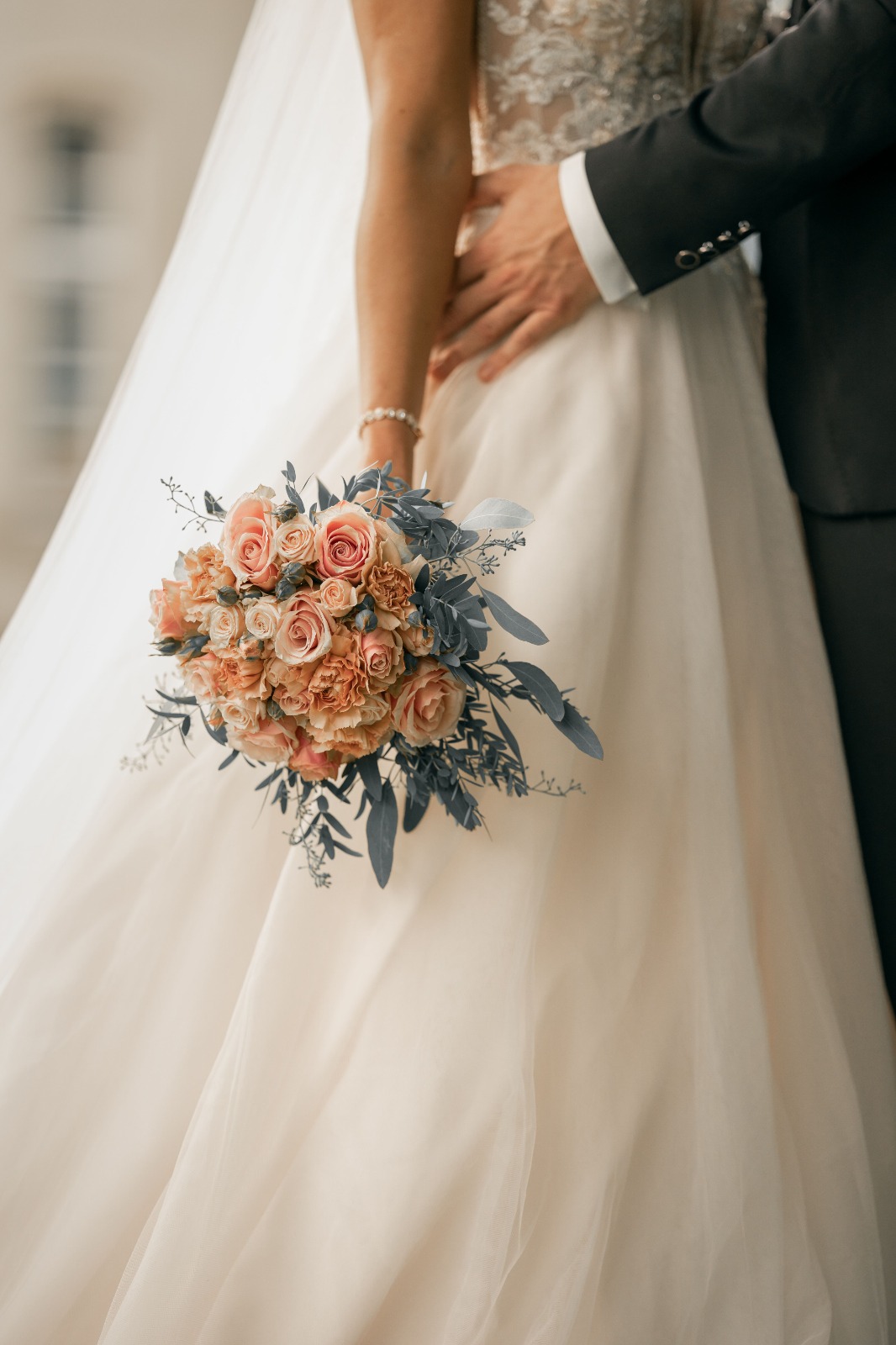 Bouquet pastel dans les mains d’une mariée
